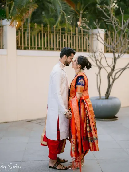 A quiet, almost-kiss moment between the bride and groom. This silhouette-like shot against a simple background emphasizes their intimacy and connection.