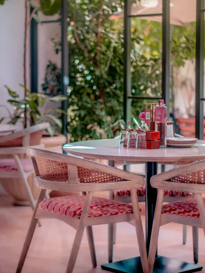 A table set for two, surrounded by greenery. This intimate corner captures the essence of Roxie: a place for quiet connection and shared experiences.