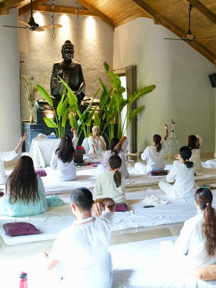 A beautiful shot of our class in a serene studio, with a Buddha statue watching over us. The environment we practice in supports our journey inward.