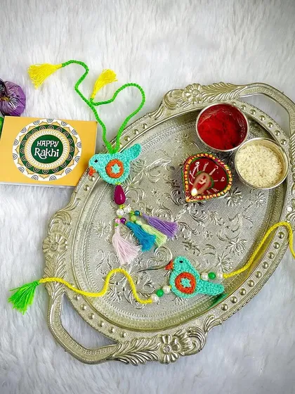 A beautiful and colorful bird-themed Rakhi and Lumba set.