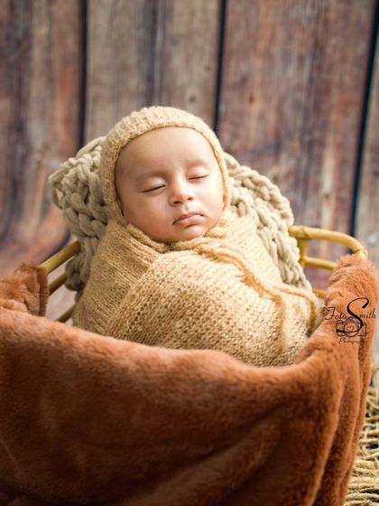 Another angle of the cozy, rustic setup, showing the baby nestled deeply in a basket lined with soft fabrics.