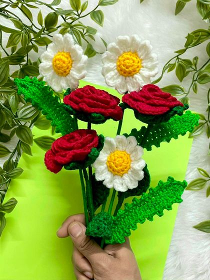 Holding a handful of happiness with these bright red roses and cheerful white daisies. This combination is so fresh and pretty, perfect for making someone smile.