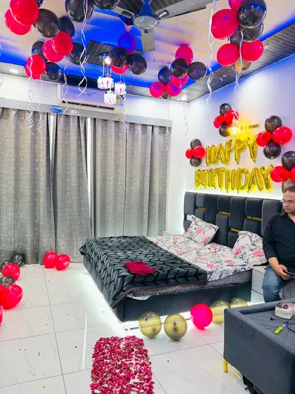 Another angle of the stylish black and red birthday room setup, showing the ceiling balloons and overall ambiance.