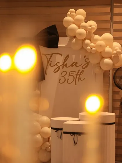 An artistic shot of the 35th birthday decor, viewed through the soft glow of candles. This image captures the warm and magical ambiance we strive to create at our events.