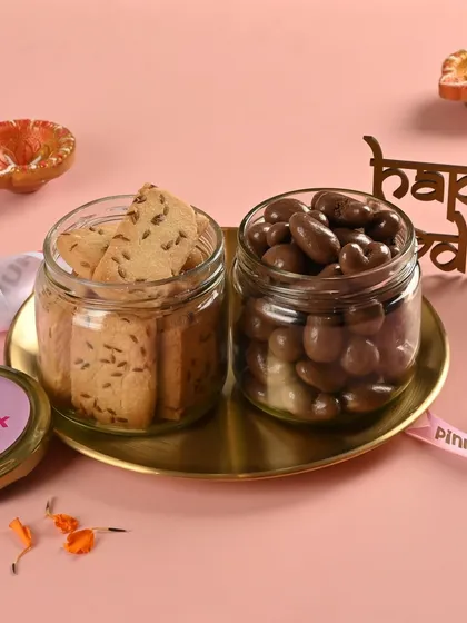 The "Lazzat" hamper offers a delicious contrast. You get the savory crunch of our Jeera Cookies alongside rich, milk chocolate-coated cashews.