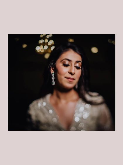 A soft-focus, artistic portrait of the bride, with beautiful bokeh lights in the background.