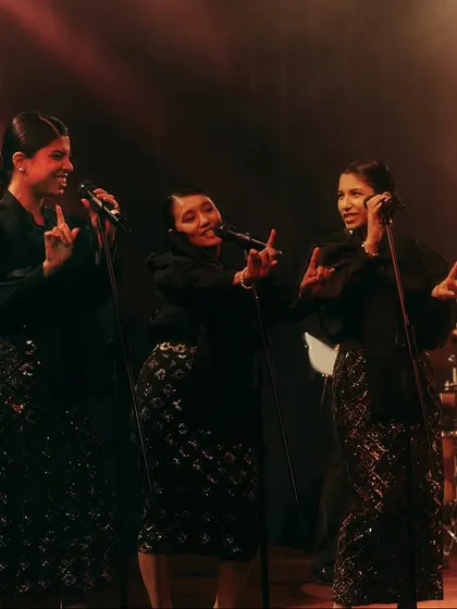 The backup singers for the jazz band, styled in coordinated black sequined outfits to look like a classic trio. Every detail in casting and styling helps build the authenticity of the scene.