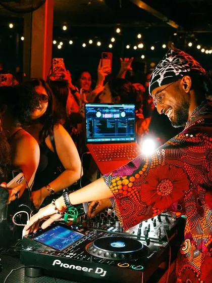 A smile on my face while I'm in the mix. I genuinely love what I do, and that passion comes through in every set I play. This was during a fantastic night at a rooftop bar in NYC.