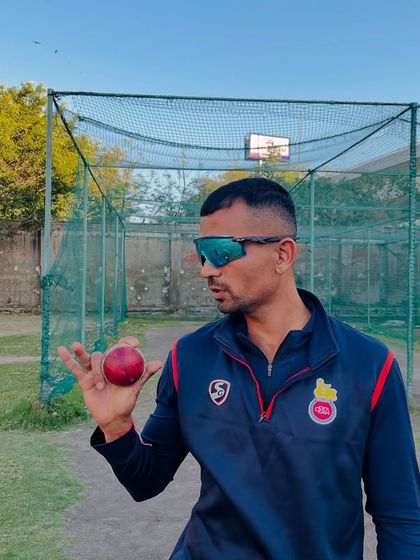 This is the grip for the carrom ball. It's all about holding the ball between the thumb, index, and middle finger to generate the flick that makes it a mystery delivery.
