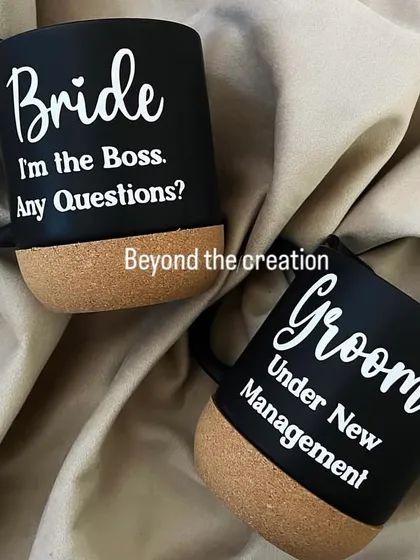 The perfect fun gift for the happy couple. These matching black cork-base mugs are customised with 'Bride I'm the Boss' and 'Groom Under New Management'.
