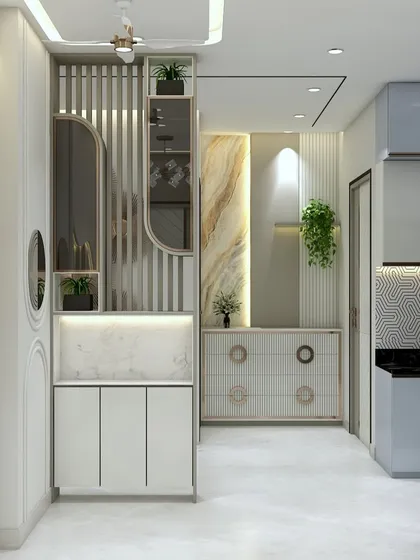 This lobby area is designed to be both beautiful and functional, featuring a stylish shoe cabinet with integrated seating and a decorative mirror. The mix of marble, fluting, and gold accents creates a luxurious entrance.