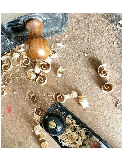The beautiful curls of wood shavings, known as "spills," created by a sharp hand plane. This is one of the most satisfying sights in woodworking.