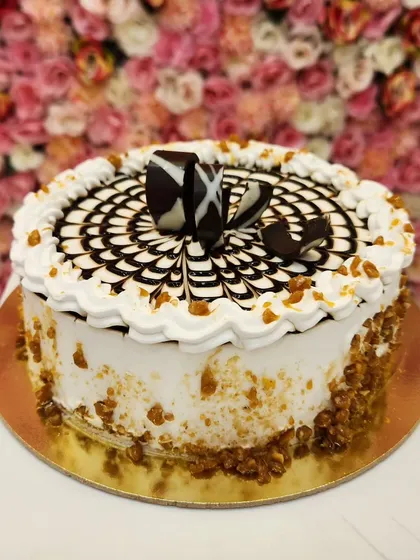 Buttery, crunchy, and sweet. My Butterscotch cake is a classic for a reason. It's decorated with a beautiful web pattern and crunchy butterscotch pieces along the side for a satisfying texture.