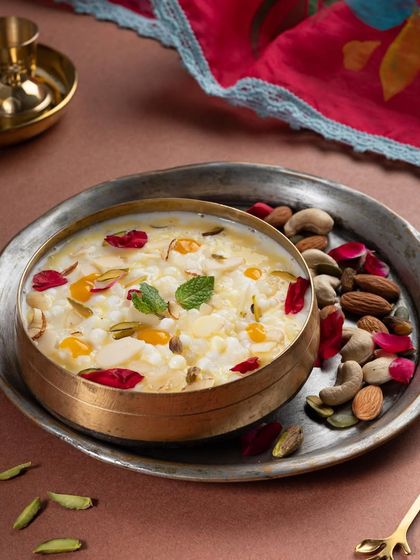 Our Diwali special Kheer, served in a traditional brass bowl. It's rich, creamy, and garnished with nuts and rose petals, making it a perfect end to your festive meal.