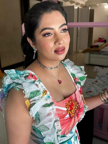 A candid moment with a client, showcasing a fresh and floral party look.