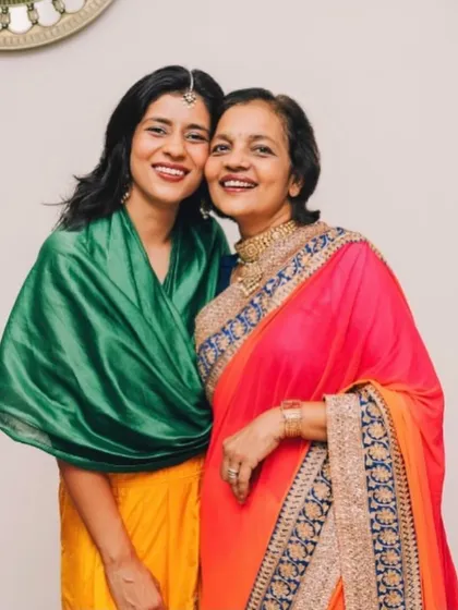 Another precious moment with my mom. Her bright, elegant saree is a testament to her timeless style.