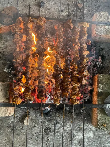 Sizzling hot Banjara Chicken, being grilled over charcoal for that authentic smoky flavor.