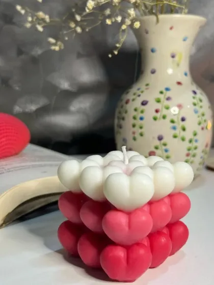 This shot highlights the unique ombre effect on our heart bubble candle. The gradual shift in color from white to deep pink makes each hand-poured candle a one-of-a-kind piece of art.