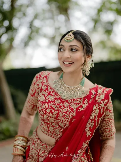 A beautiful candid shot of the bride. Her soft glam makeup looks stunning in the natural outdoor light, highlighting her features with a gentle radiance.