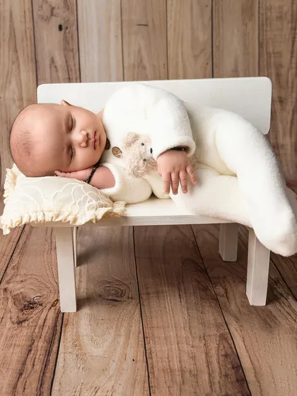 Sleeping peacefully in dreamland. I use simple props like this miniature bench to create a timeless and adorable scene for your newborn.