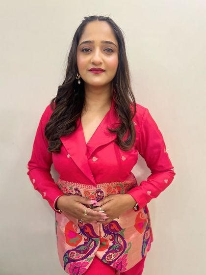 A classic portrait of Aditi. The makeup is clean and bright, with defined eyes and a beautiful lip color that complements her unique Paithani-style blazer.