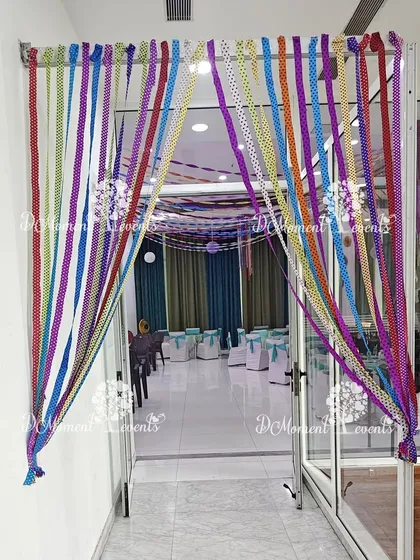 A close-up of the handmade ribbon curtain entrance, showing the variety of colors and patterns used to create a playful and crafty feel.