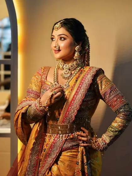 A regal pose showing the full splendor of a Maharashtrian bridal outfit. The layered jewellery and embroidered saree are the stars of this traditional look.