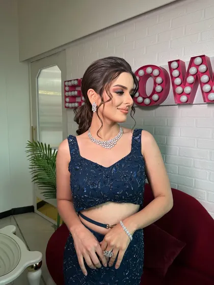 A soft signature glam makeup look for a cocktail night. This bride came to us with a vision, and we delivered with sculpted eyes, a flawless base, and a chic ponytail.