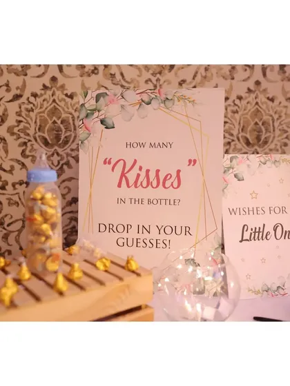 Fun and games for everyone! We set up a "How many kisses in the bottle?" guessing game and a "Wishes for the Little One" station for guests to participate in.