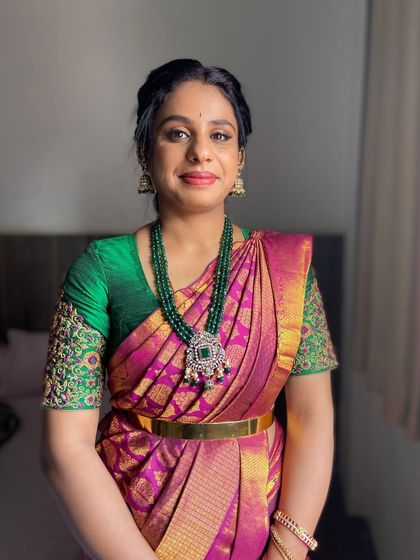 A close-up portrait of the wedding guest, showcasing her radiant skin and a makeup look that enhances her natural features.