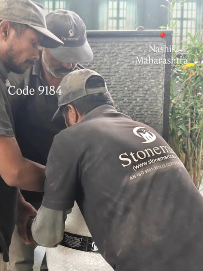 My team works together to position the large Buddha fountain for its final checks before packing.