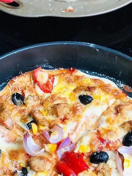 The final result of a lot of love and patience: a freshly baked homemade pizza. This one is loaded with chicken, colorful peppers, onions, and olives on my signature from-scratch crust.