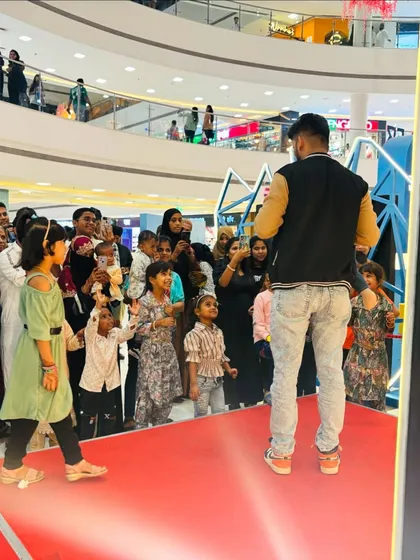The audience of kids and families completely captivated during my performance at a mall event.