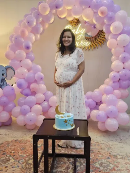 Another shot of the lovely baby shower setup, showing the full circular balloon arch, the "BABY" display boxes, and the themed cake ready for celebration.
