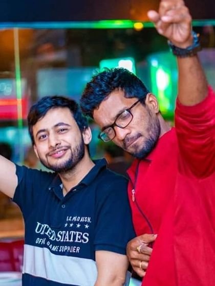 Two friends pointing to the beat. It is awesome to see the crowd getting into the music and feeling the rhythm.