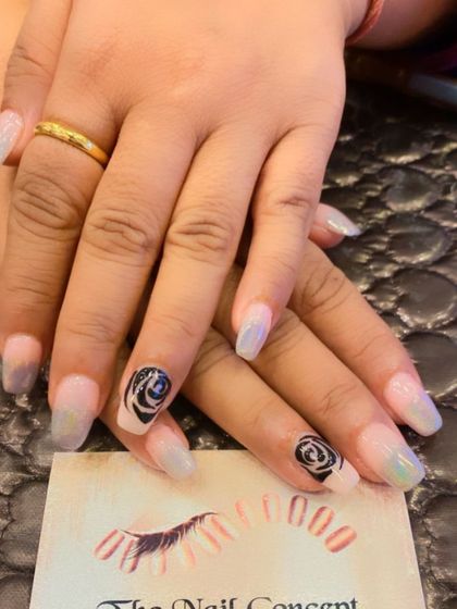 A mystical and elegant design on long, clear coffin nails. The accent nails feature a beautiful, hand-painted black and white rose design.