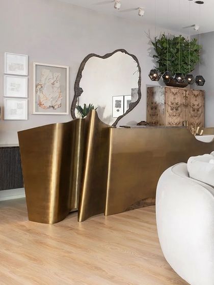 The 'Tango Bar' from our Koko collection is a true statement piece, its form inspired by the wave-like movement of paper. Crafted from brass sheets over a steel structure, it is both a functional bar and a powerful sculpture.