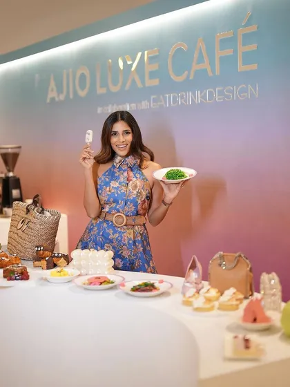 Mitali from House of Misu posing at the Ajio Luxe Café with a selection of our curated dishes. It shows the beautiful and photogenic spread we created for the event.
