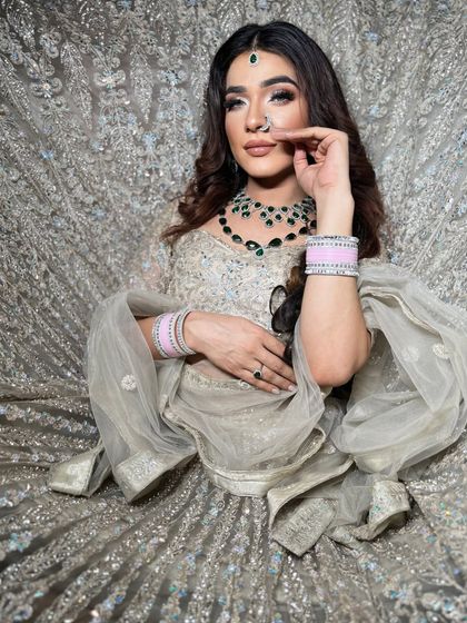 A full view of the bride lost in her magnificent silver lehenga. A truly royal look.