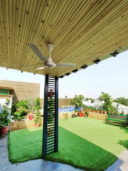 A wider view of the pergola and the surrounding garden, showing how it creates a shaded and comfortable zone within the larger space.