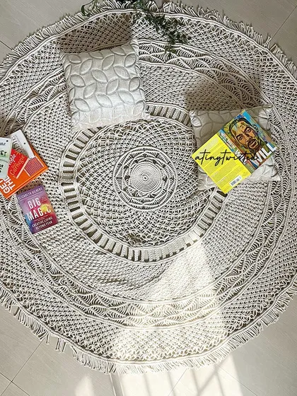 A flat-lay view of my intricately designed round macramé rug. It's handmade with soft but thick cotton yarn, making it non-slippery and perfect for a living room, bedroom, or even a nursery.