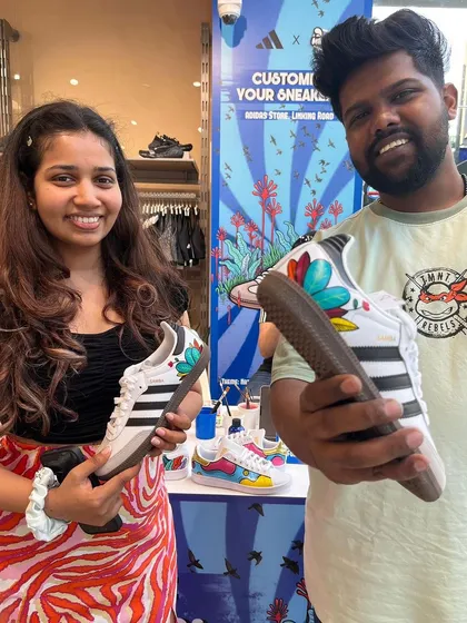It's a team effort. This couple left with a pair of custom-painted Adidas Sambas featuring a vibrant, nature-inspired floral design, created live at our in-store event.