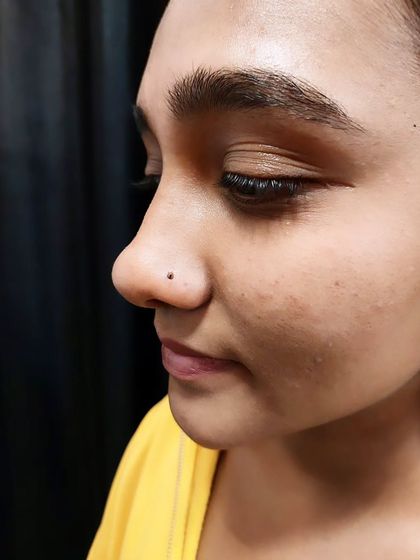 A close-up of a nostril piercing with a dark stud. I have various nose stud options to choose from.