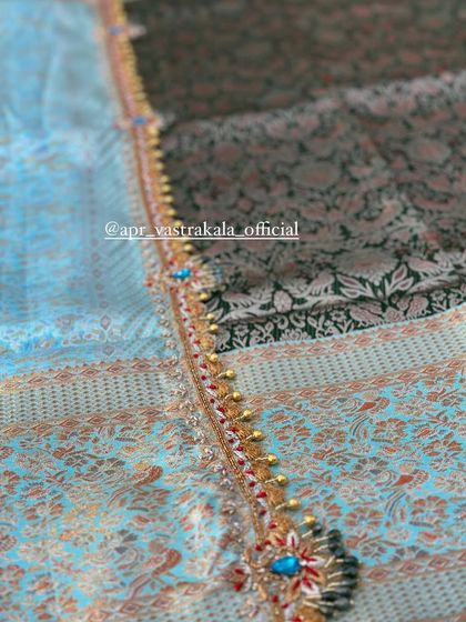 A close-up of the intricate border, showing the detail of the stone and beadwork.