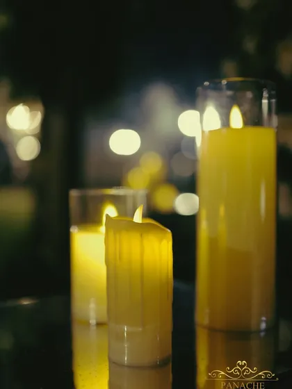 A close-up of the candle decor, using mirrored pedestals to amplify the warm, flickering light and create a romantic glow.