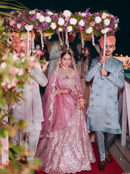 The bridal entry under a phoolon ki chaadar. Tanisha's makeup is elegant and timeless, with a focus on flawless skin that looks perfect both in person and on camera.