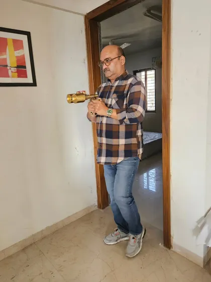 Using my energy scanner in a bedroom doorway. This helps me determine the flow of energy into the room, which impacts sleep quality and relationships.