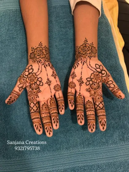 A delicate floral design on the back of the hands, ideal for guests at a wedding or a festive party.