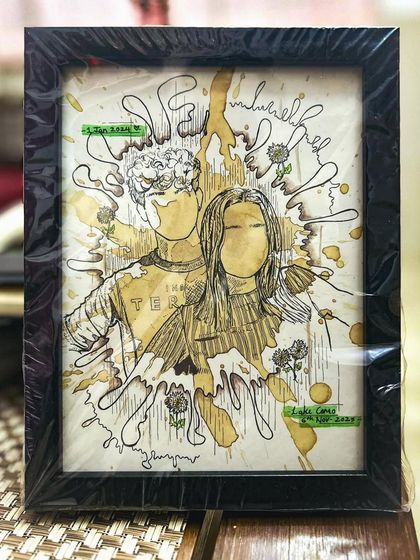 A framed custom illustration that uses coffee splashes and fine-line art to create a dynamic portrait. The abstract background adds a lot of energy to the piece.