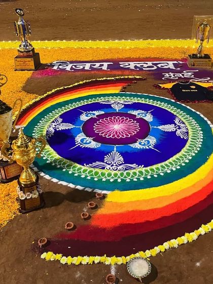 The vibrant colors of our Laxmi Pujan rangoli, surrounded by our championship trophies.